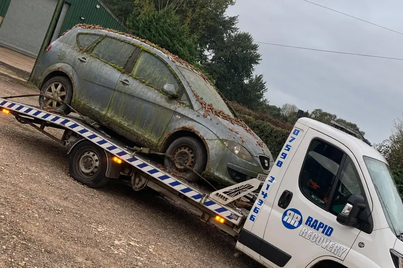 A scrap car loaded on one of our collection trucks near Caldecott